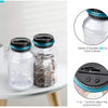 A clear plastic counting piggy bank with a black lid and a blue accent, shown next to coins.