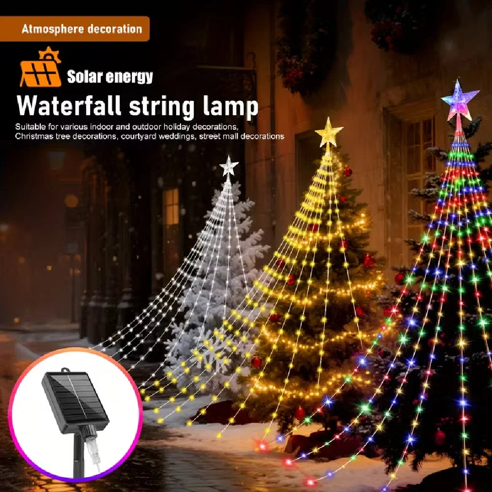 A close-up of a solar energy waterfall string lamp illuminating a Christmas tree with warm yellow and multicolored lights.