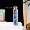A glass bottle filled with blue lapis lazuli crystals, labeled as lapis lazuli.