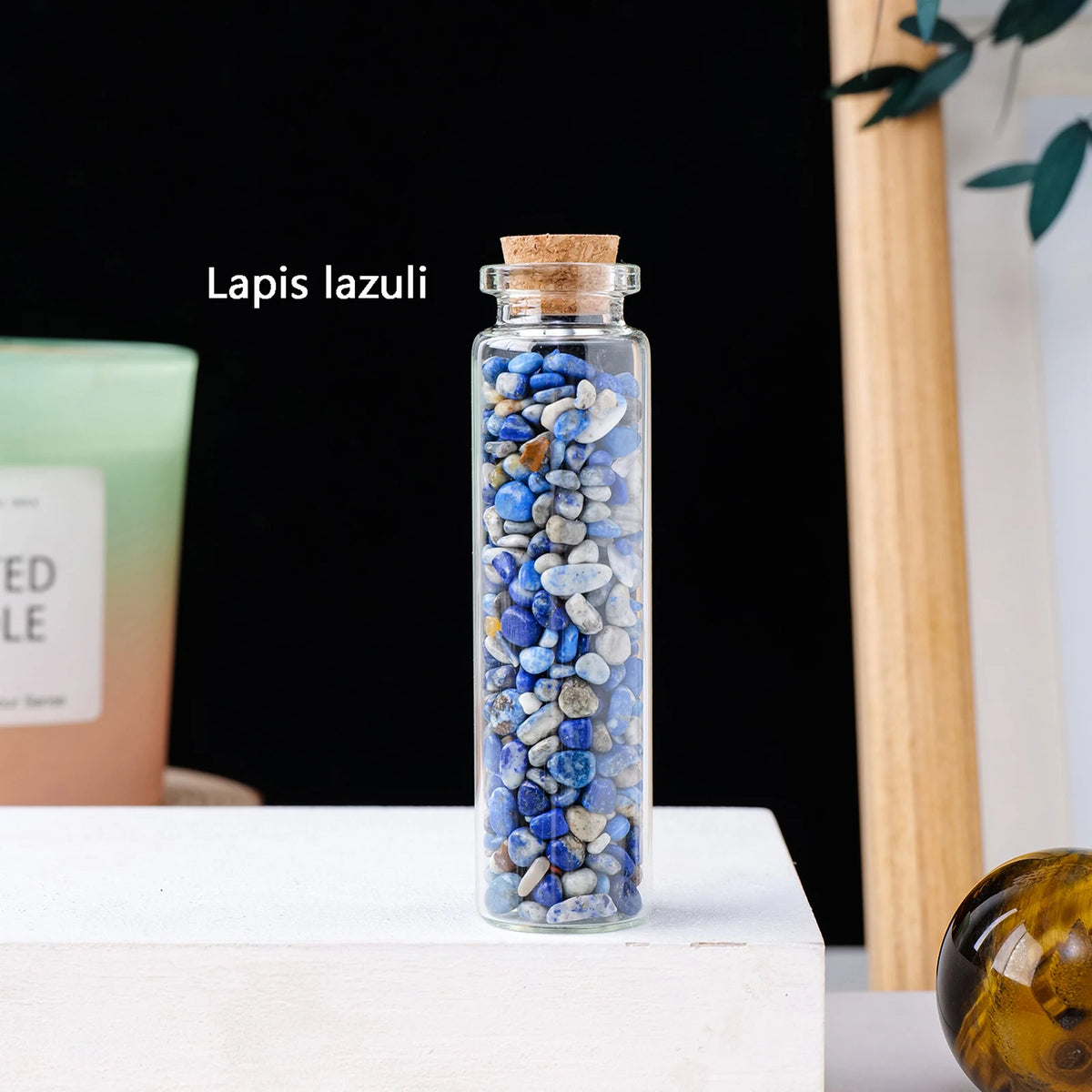 A glass bottle filled with blue lapis lazuli crystals, labeled as lapis lazuli.
