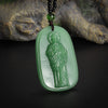 A green jade pendant featuring a statue of Saint Jude Thaddeus on a dark cord.