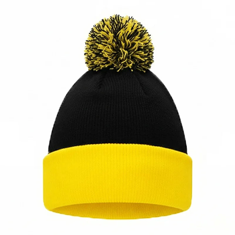 Black knitted beanie with a yellow brim and a yellow pom-pom.