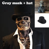 A realistic latex skull mask worn by a person, featuring a black hat and dark clothing.