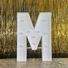 A large white marquee letter M with round lights displayed against a gold metallic curtain background.