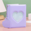 A purple candy heart window photocard album with a heart-shaped clear window and a silver chain.