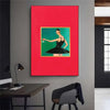 A vibrant red canvas wall art featuring a stylized portrait of a woman in a black dress.
