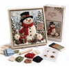 A box and framed artwork for a 3D fabric poke art kit featuring a snowman and winter forest scene.