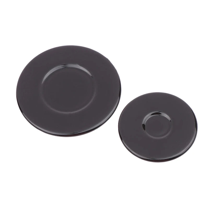 A set of black gas stove burner caps for efficient cooking.