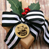 A brown kraft paper gift box tied with a black and white striped ribbon featuring a round thank you sticker.