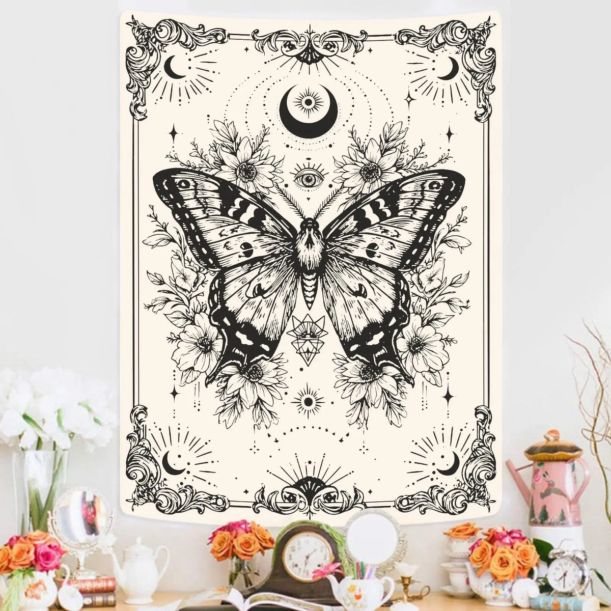 Black and white line art tapestry featuring a butterfly surrounded by celestial elements like moons and stars