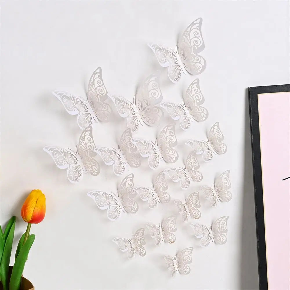 A set of white 3D hollow butterfly wall decals displayed against a white background next to a yellow tulip.