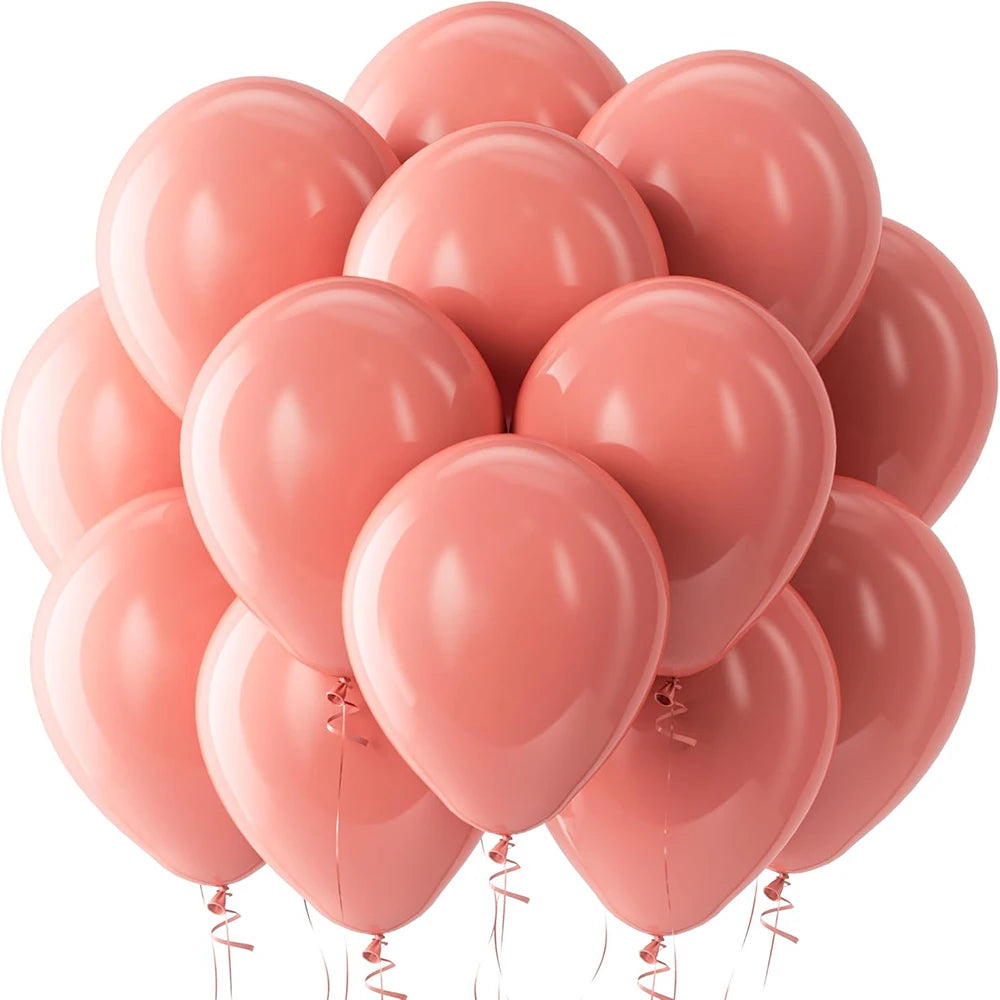 A cluster of pink latex balloons, some heart-shaped, are shown against a white background.