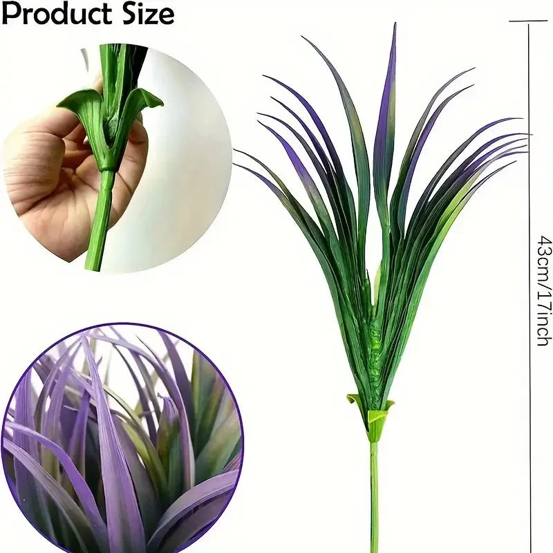A close-up view of artificial tall grass and tropical flowers showing their size and texture.