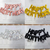 A set of foil letter balloons spelling HAPPY BIRTHDAY in pink, gold, and silver colors for a birthday party decoration.