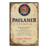 Vintage metal sign for Paulaner Premium beer featuring German text and logo.