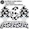 A set of cow print number balloons and latex balloons with a tablecloth for a farm-themed party decoration.