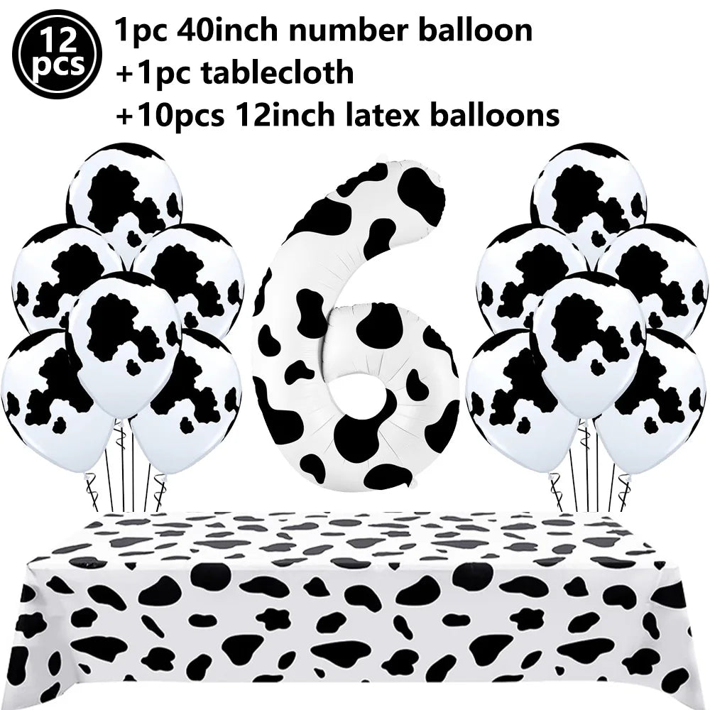 A set of cow print number balloons and latex balloons with a tablecloth for a farm-themed party decoration.