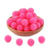 A pile of bright pink textured resin beads for jewelry making
