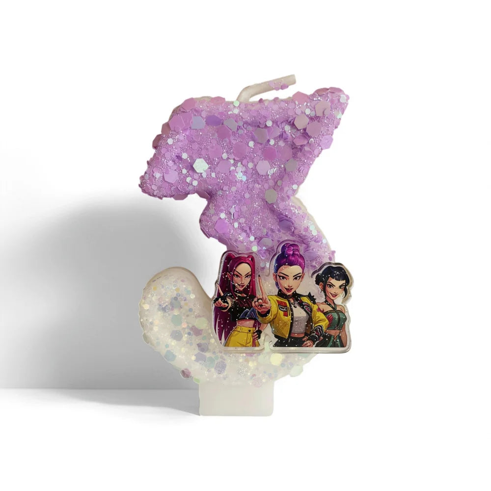 A purple glitter candle shaped like a unicorn, featuring three character figures.