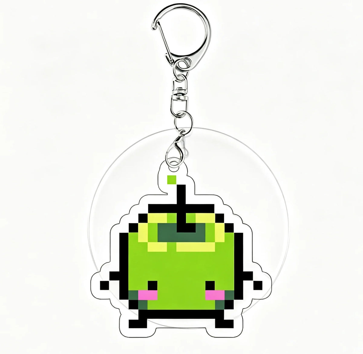 A clear acrylic keychain charm featuring a pixel art green monster face.