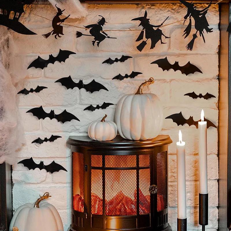 A display of black bat wall stickers and white pumpkins on a rustic brick wall.