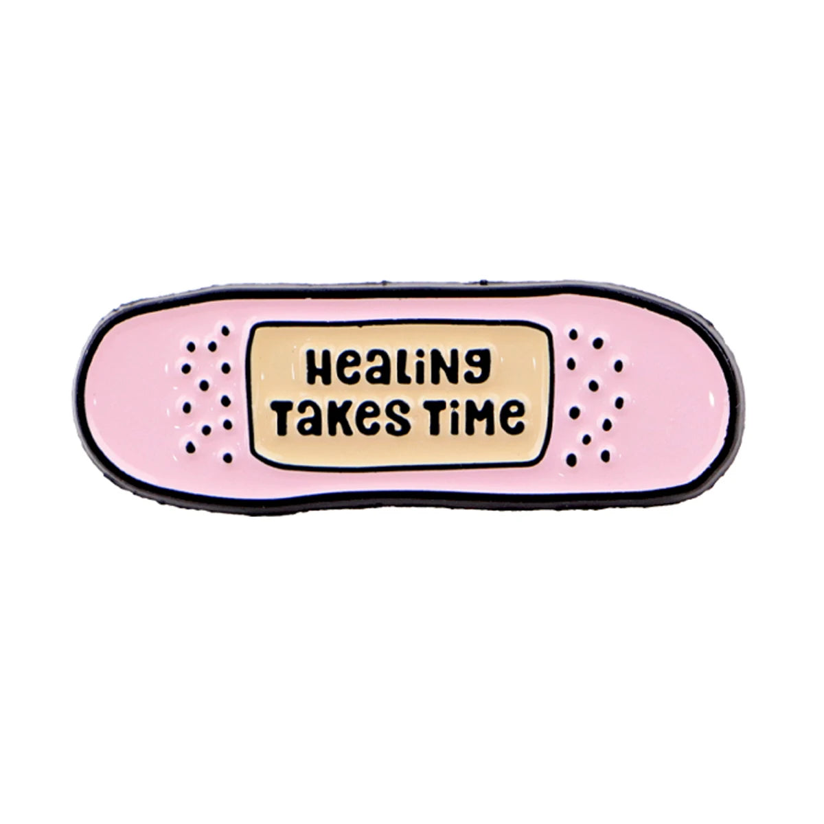 A pink enamel pin with the text Healing Takes Time in black lettering and yellow background.