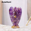 A natural amethyst crystal figurine shaped like a guardian angel with gold accents.