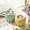A light green silicone mold filled with clear crystals sits next to a yellow textured mold on a white table.