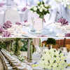 A bouquet of white artificial silk roses displayed on a table setting.