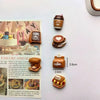 A set of colorful coffee bean fridge magnets featuring various coffee-themed designs.