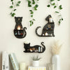 A black cat wall shelf featuring a moon phase design and small candles, decorated with green vines.
