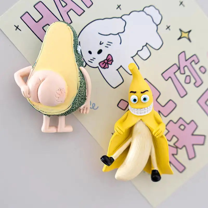 A set of cute 3D fruit fridge magnets featuring a yellow banana and a green avocado.