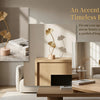 A set of golden Ginkgo leaf ornaments displayed on a wooden table in a modern interior setting.