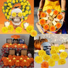 A collection of artificial orange and yellow carnation and marigold flower heads used for festive decoration.