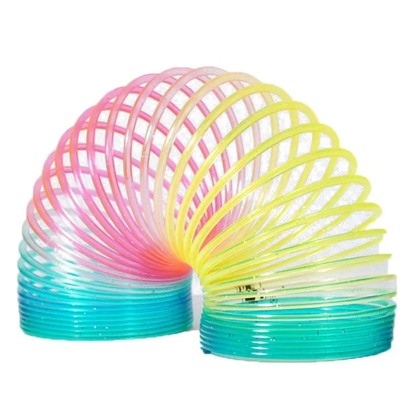 Rainbow spring circus party favors for kids in a spiral arrangement of pink, yellow, and blue plastic rings