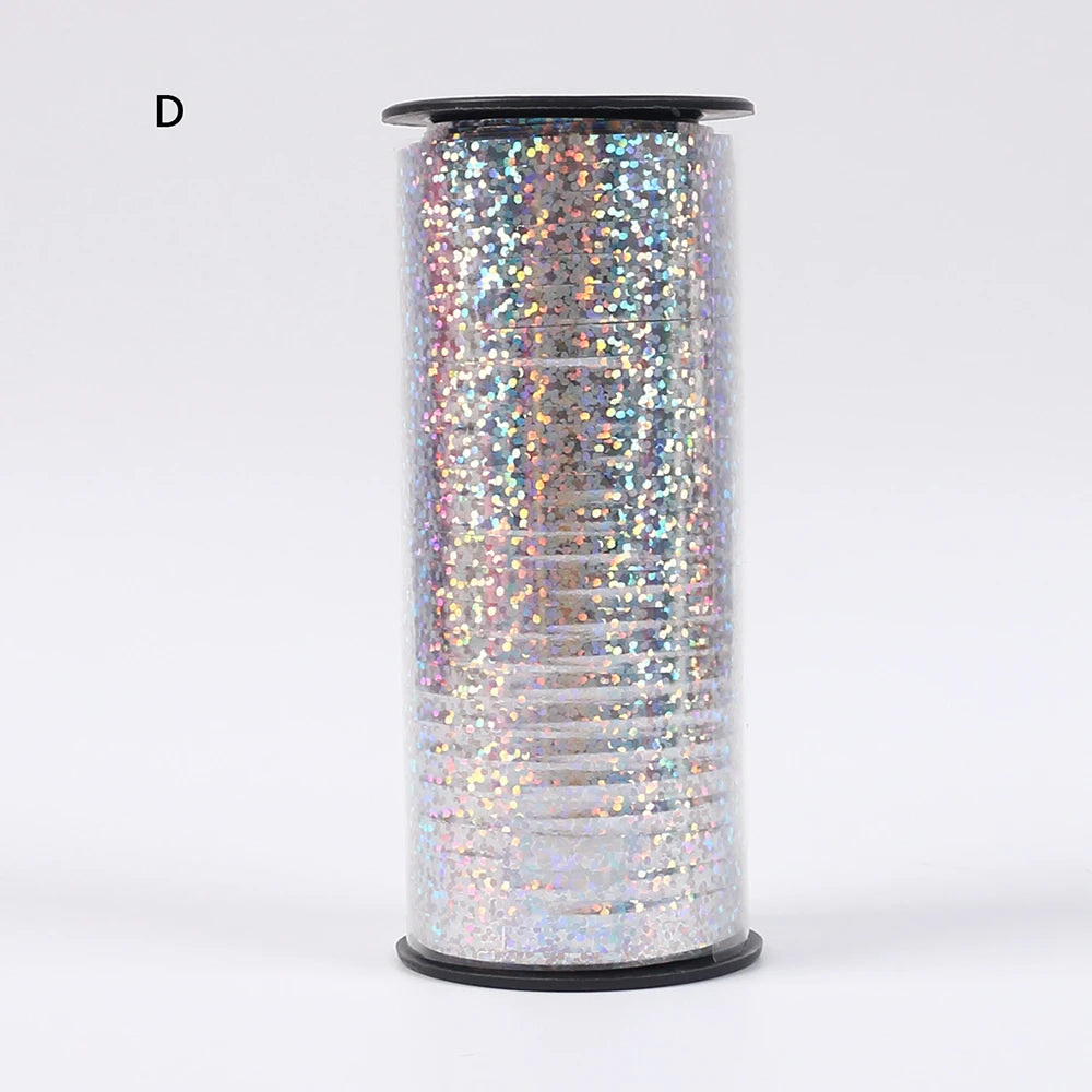 A roll of iridescent glitter curling ribbon used for gift wrapping and party decor.
