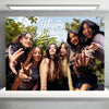 A group of six young women smiling and posing for a birthday photo in an outdoor setting.