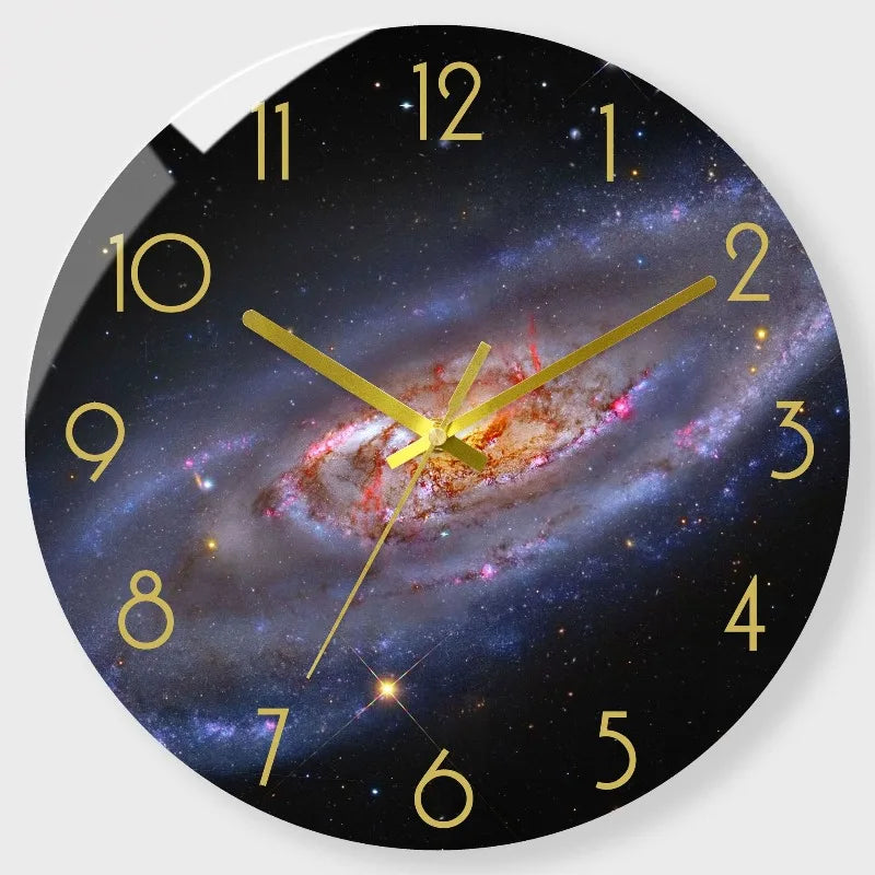 A round wall clock face featuring a dark background and a colorful spiral galaxy design.