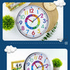 A colorful silent wall clock with a round face and decorative elements is shown on a wooden surface.
