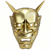 A full face Japanese Hannya demon mask with horns and fierce facial features, colored gold.