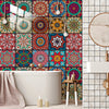 Colorful mandala peel and stick wall tiles used as a kitchen backsplash with candles.