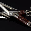 A close-up of a full-size katana replica prop featuring silver and dark red accents.