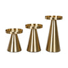 A set of three elegant gold metal candle holders with tapered bases and circular tops.