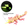 A pink chameleon fidget toy with glowing yellow horns and eyes, shown next to a magnified view of the glow.