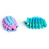 A pair of articulated 3D printed hedgehog figurines in shades of purple and blue.