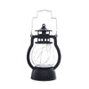 A black LED lantern night light with a clear glass globe and a decorative top, emitting a warm glow.