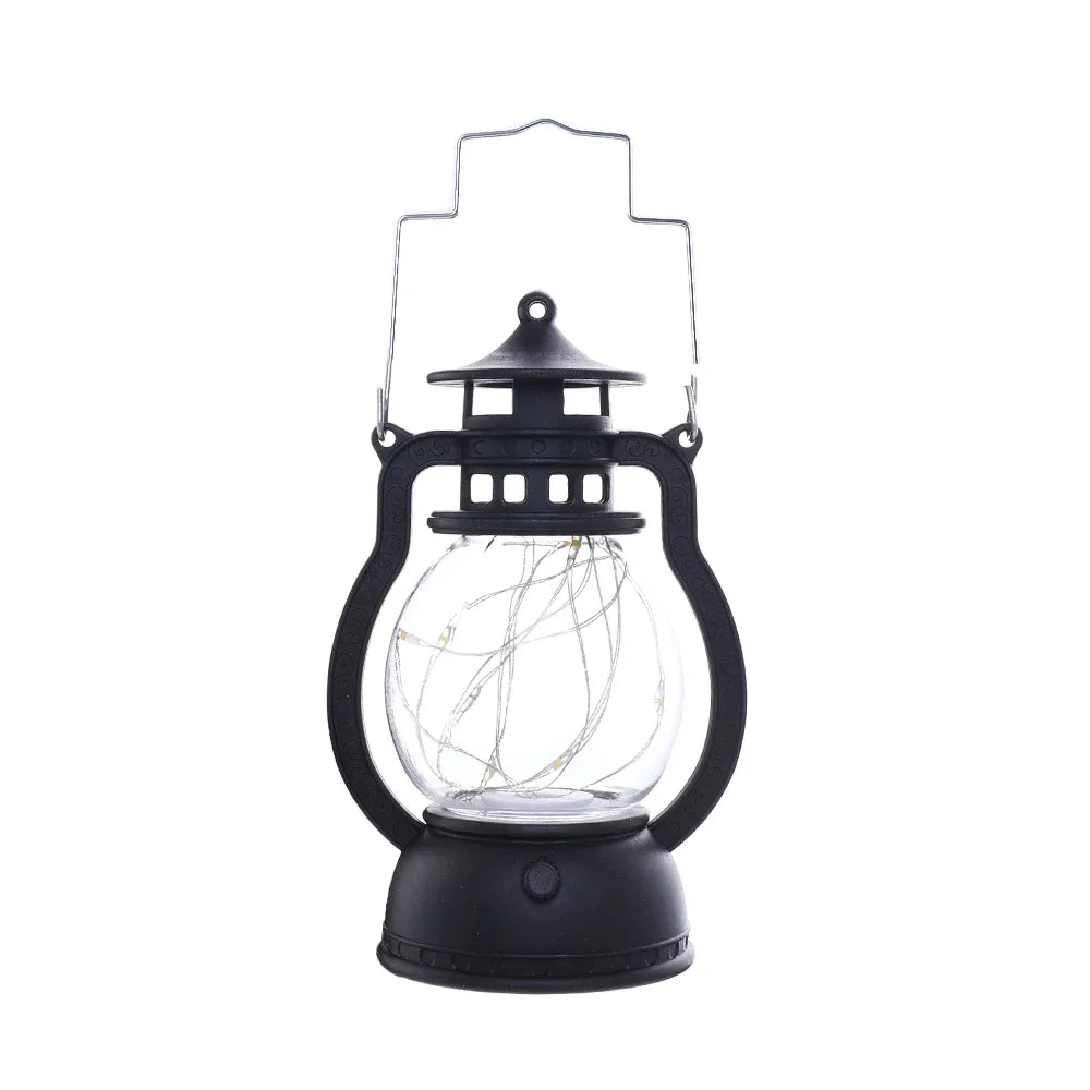 A black LED lantern night light with a clear glass globe and a decorative top, emitting a warm glow.