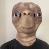 A realistic cute alien full-face latex mask with large eyes and wrinkled skin.