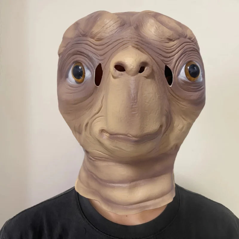 A realistic cute alien full-face latex mask with large eyes and wrinkled skin.