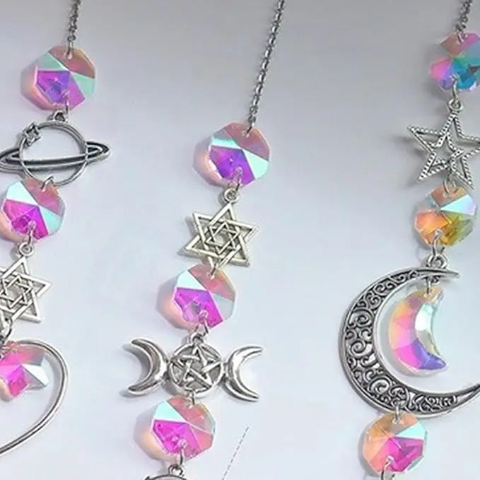 Silver pendant necklace featuring iridescent crystal wind chimes shaped like an atom, star, moon, and crescent.